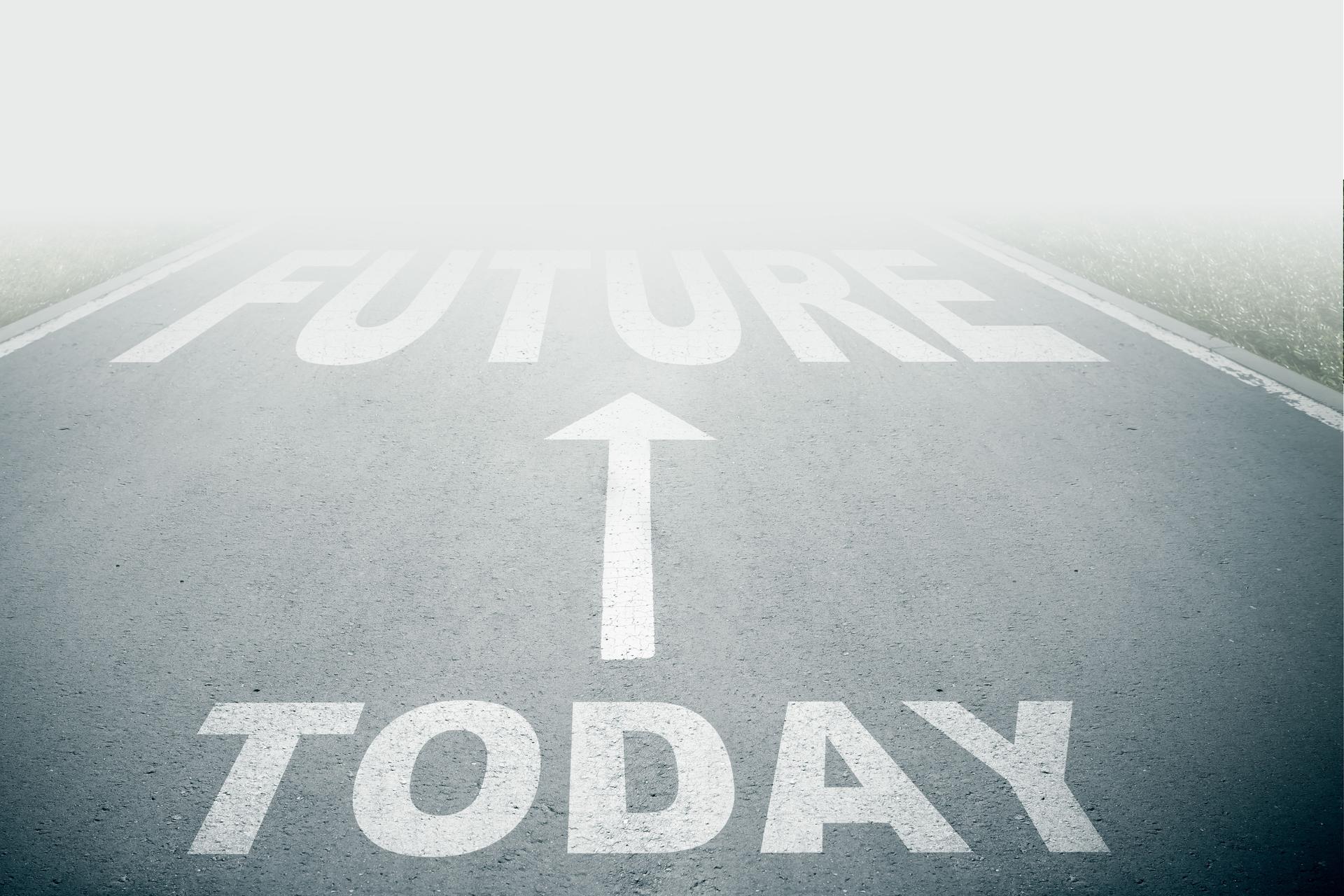 Today next to future text on asphalt road with white arrow sign on road goes into fog. Direction way sign. Moving forward concept. Unclear ahead or negative tomorrow concept.
